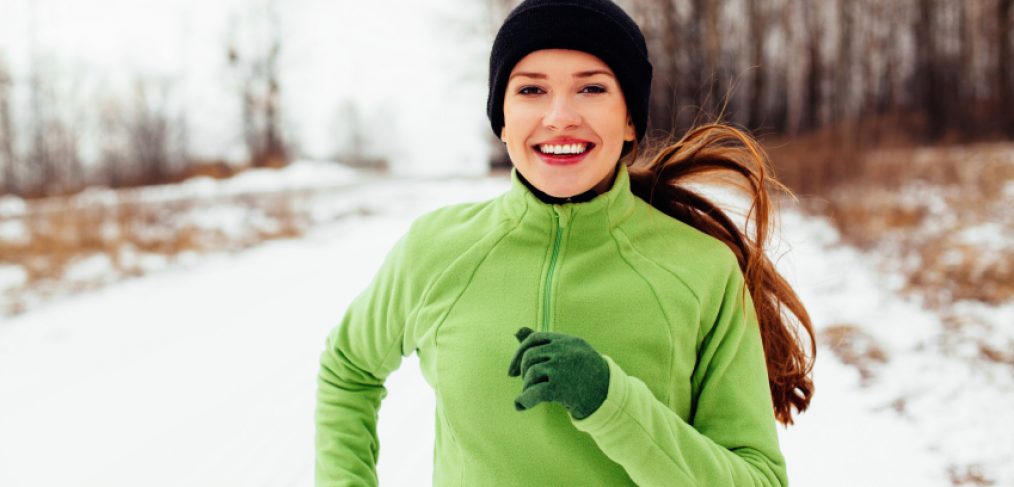 Happy young woman exercising in winter