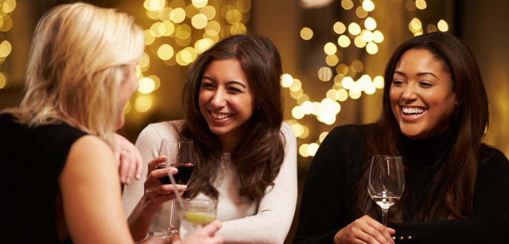 Group of women having fun and drinking wine