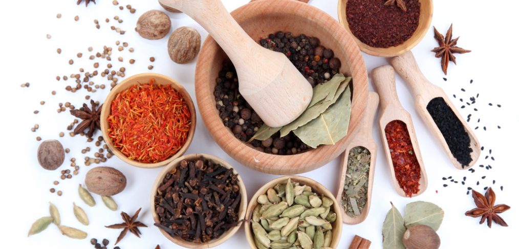 Various spices in bowls and spoons