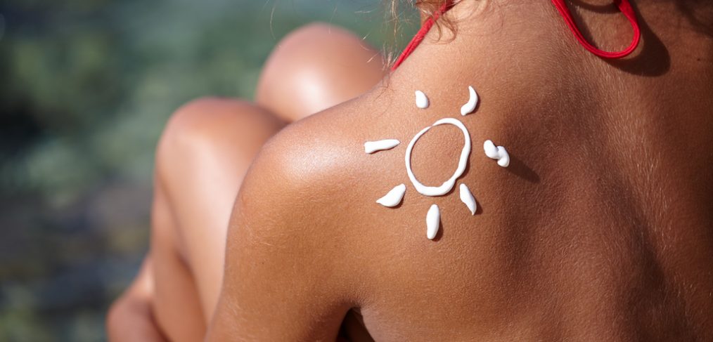 Sunscreen on woman's shoulder outdoors