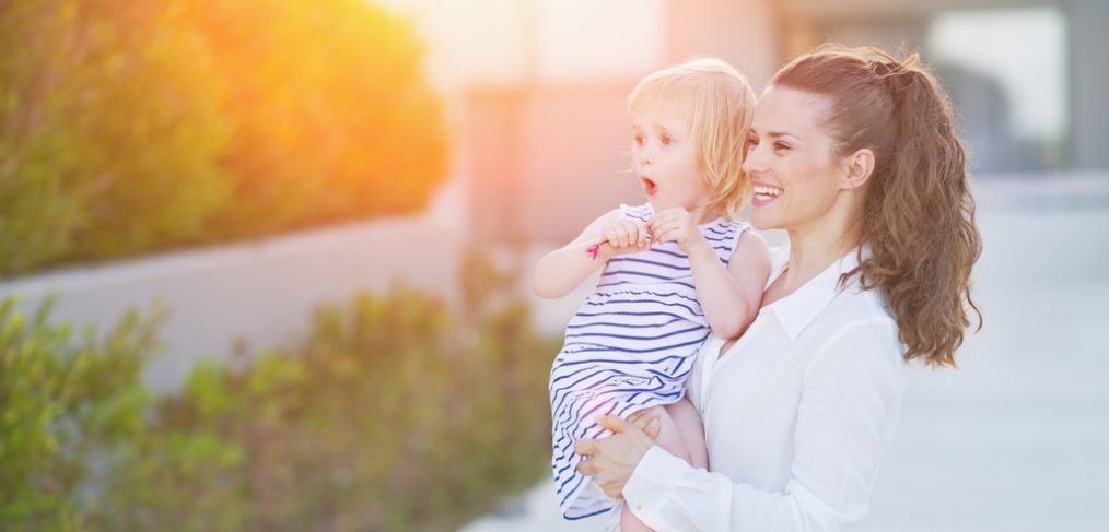 Mother with her daughter in her backyard.