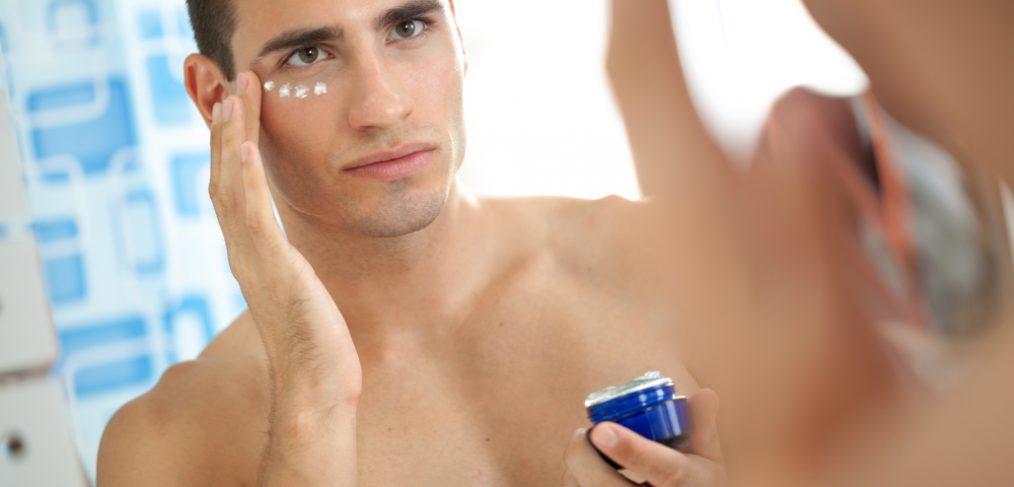 Man applying anti-aging cream.