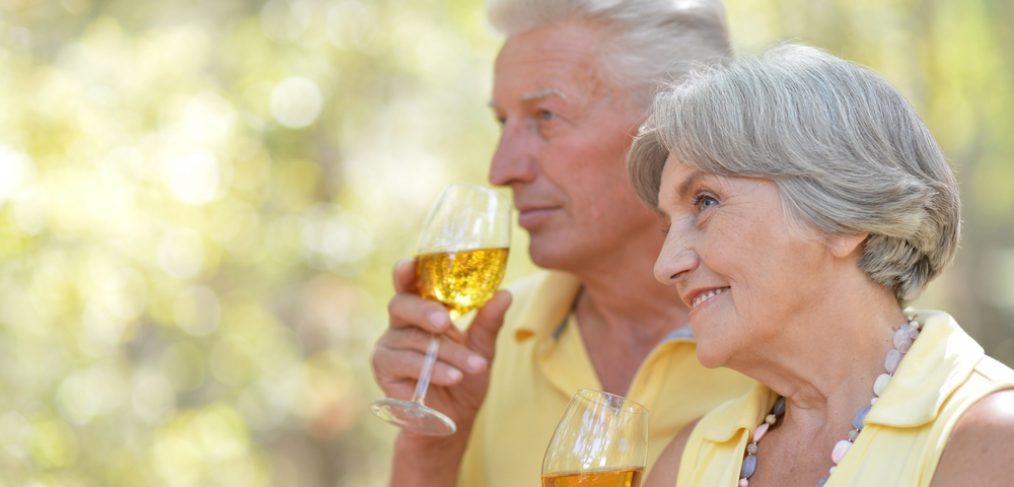 Old couple drinking wine.