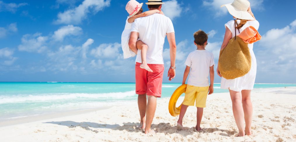 Family walking on a beach.