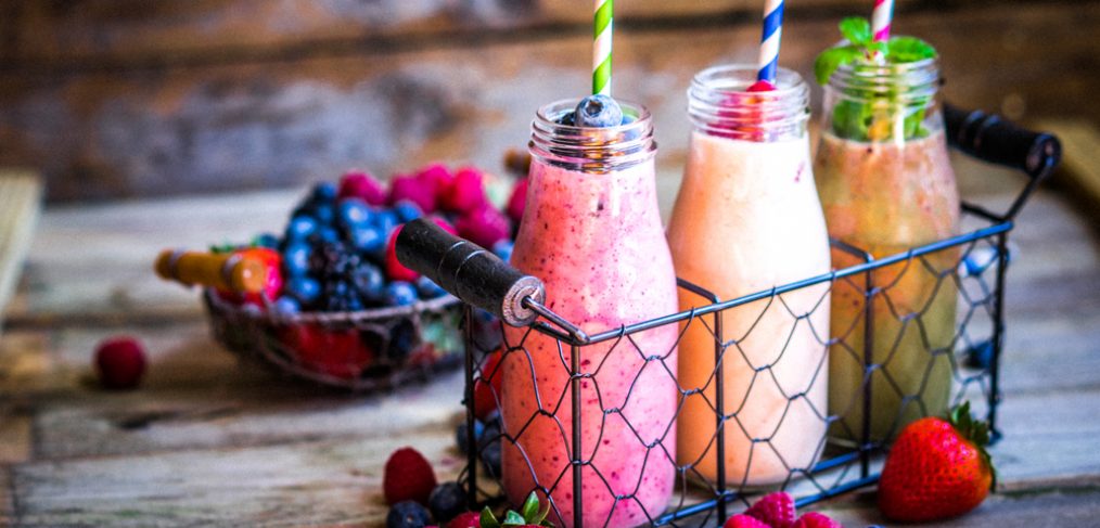 Smoothies on a wooden table.