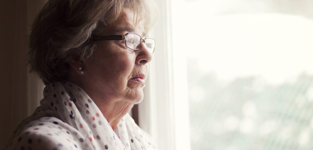 Old woman looking out of the window