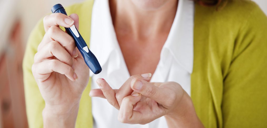 Woman testing for diabetes