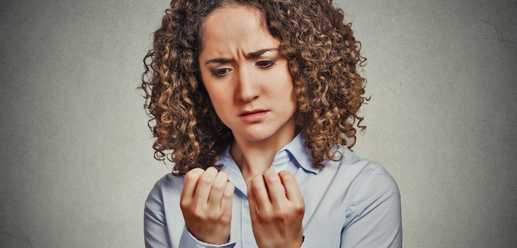 Woman looking at finger nails