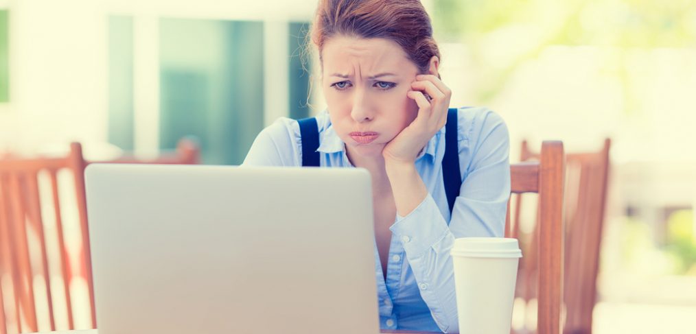 Woman squinting at laptop