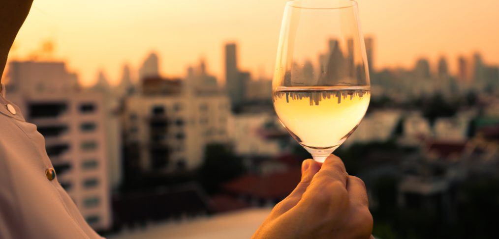 Woman having wine at sunset