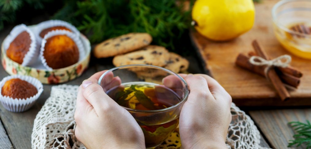 Woman's hands holding cup of green tea