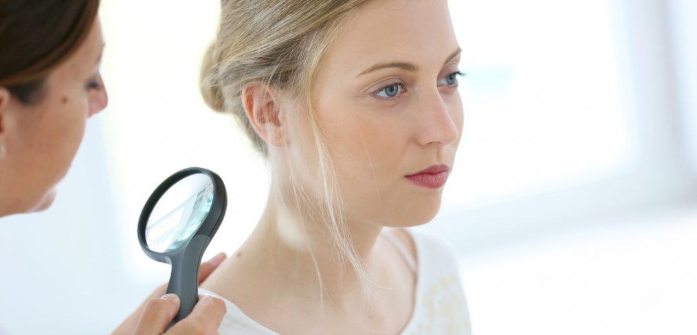 Woman getting her skin examined