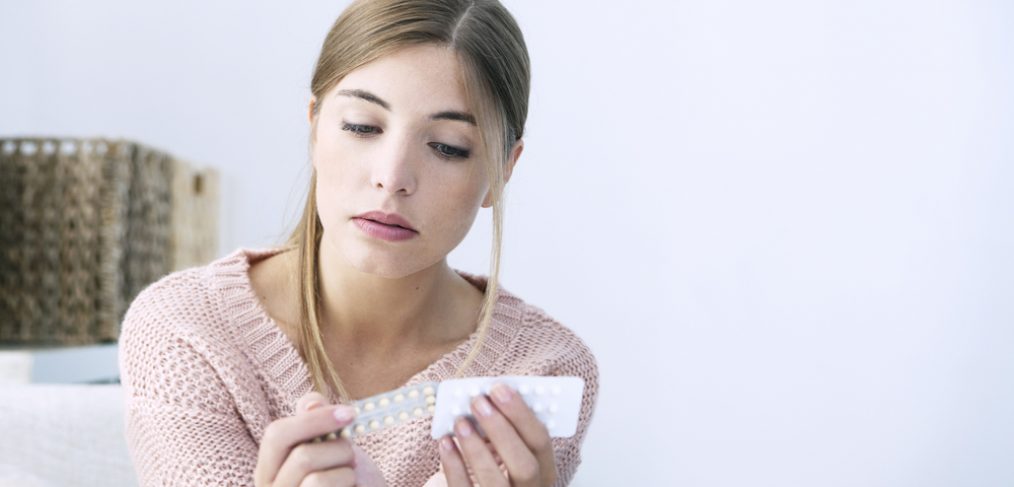 Woman taking a pill