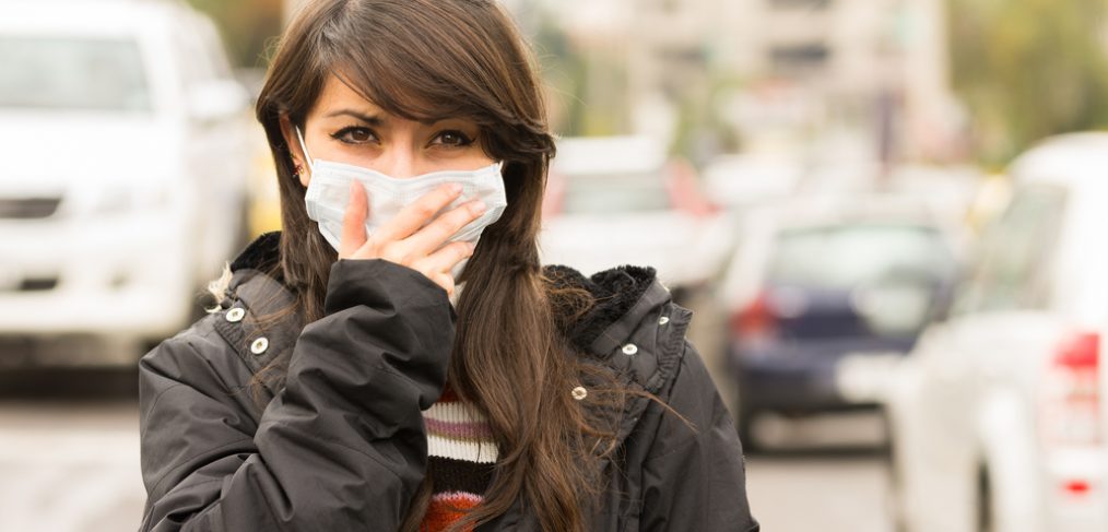 Women walking in polluted air with a mask