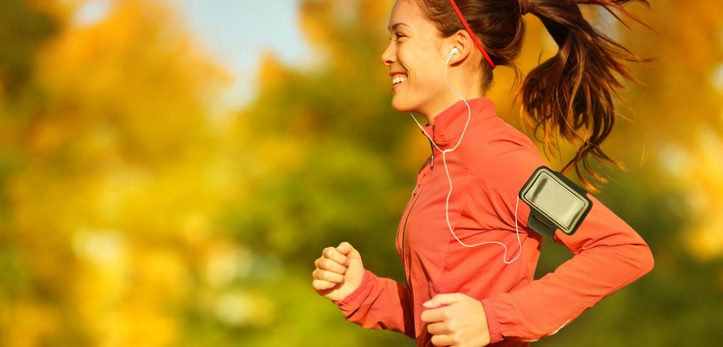 Woman running outdoors during fall season