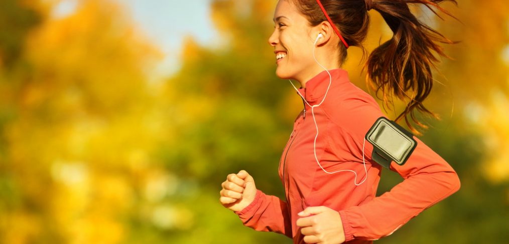 Woman running outdoors during fall season