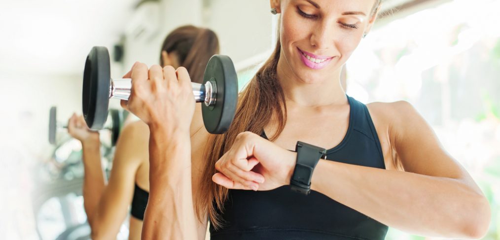 Woman working out while looking at wrist watch