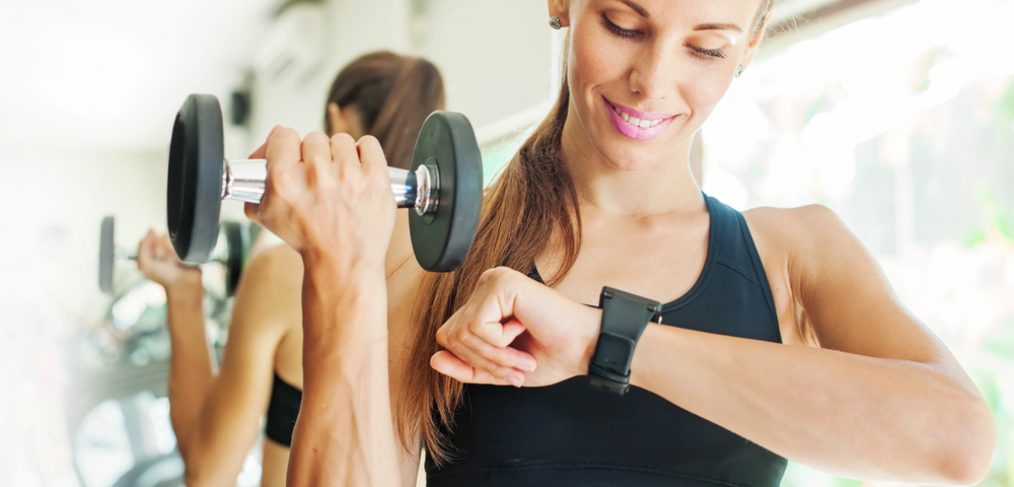 Woman working out while looking at wrist watch
