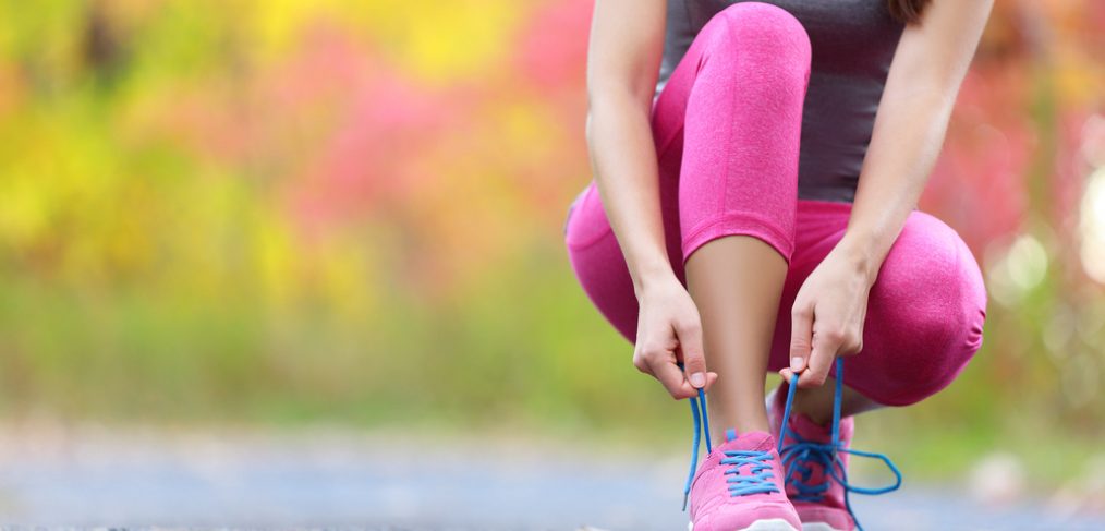 Woman tying up her shoelaces