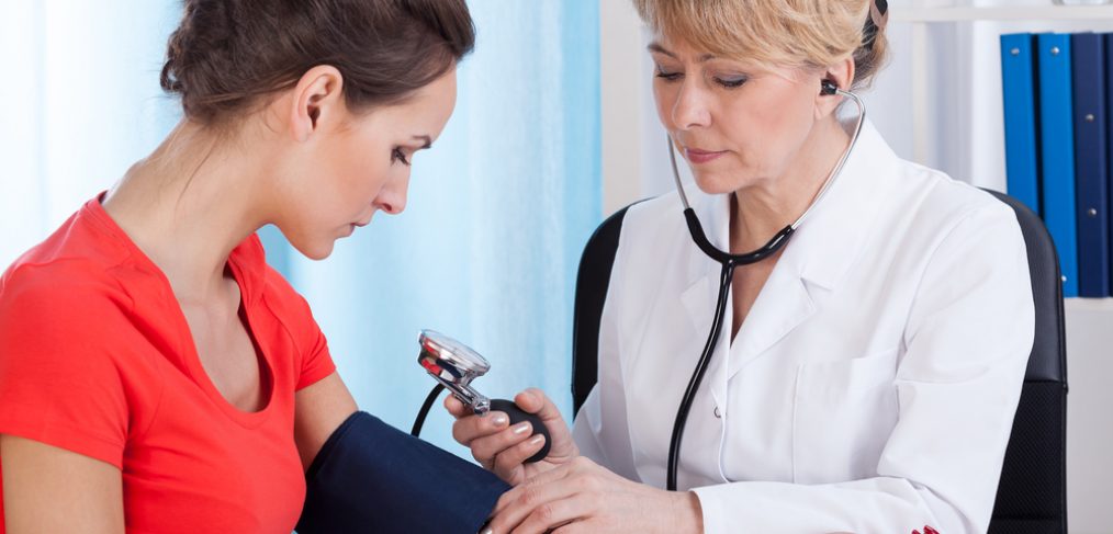 Doctor taking blood pressure