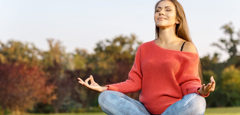 Woman meditating on grass