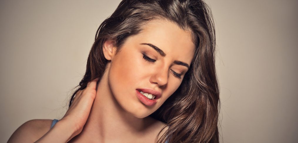 Woman massaging painful neck