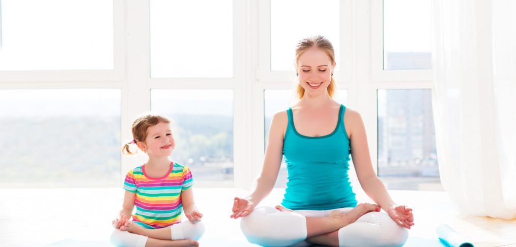 Mother and child doing yoga pose