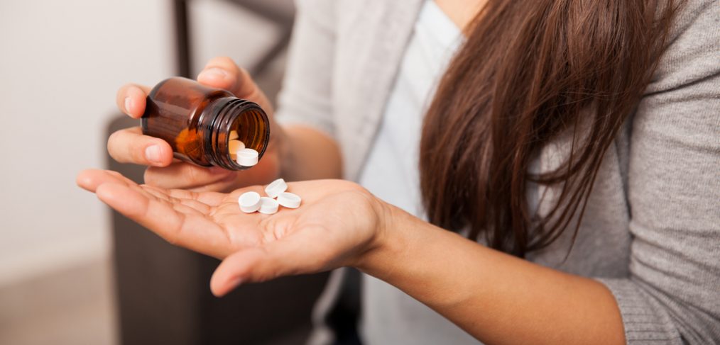 Aspirin in woman's hand