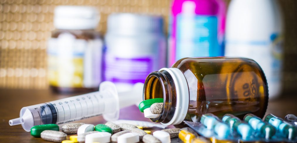 Pills and medicine on wooden table