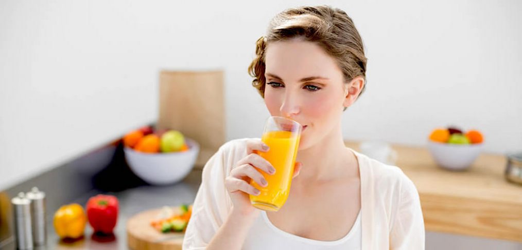 Young woman drinking orange juice