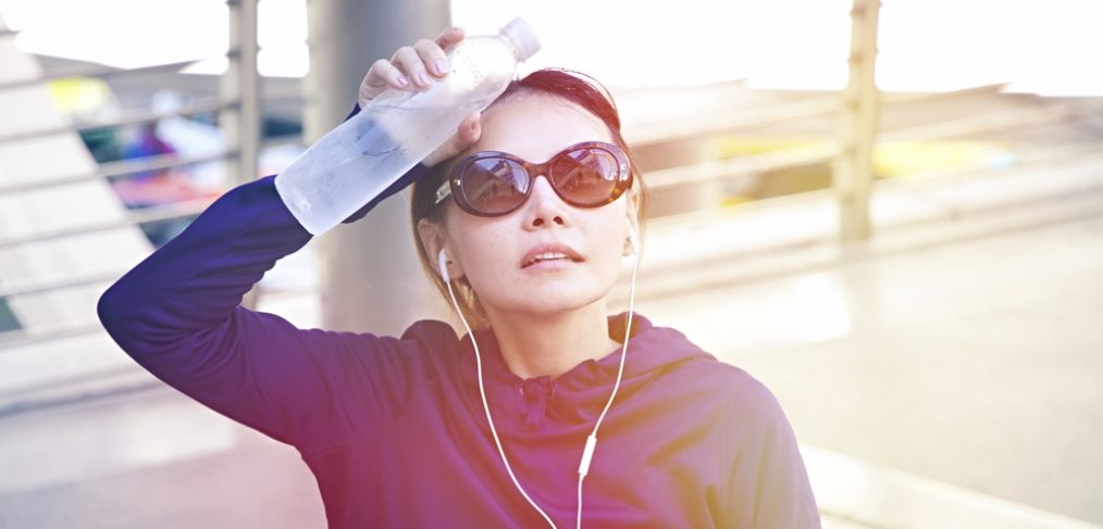 Dehydrated woman with a bottle of water outdoors