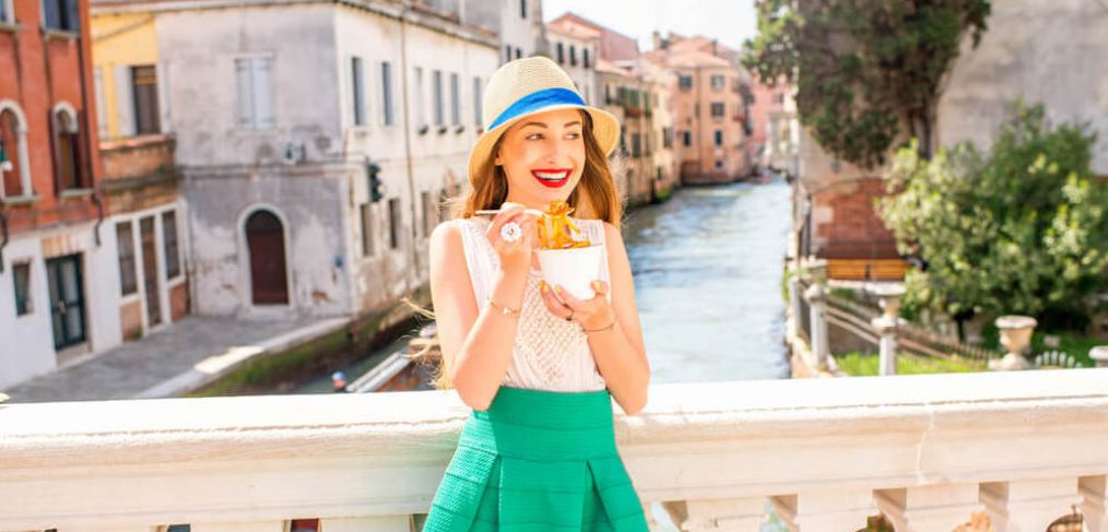 Young woman enjoying spaghetti in Italy