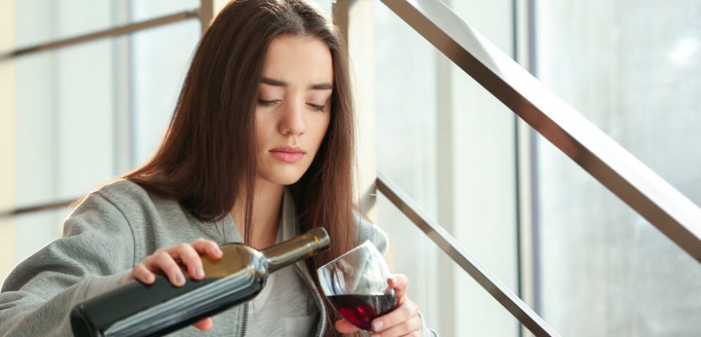 woman poring wine into glass