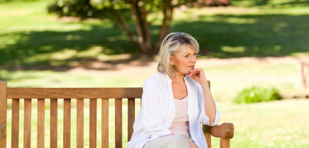 Contemplative woman on a park bench