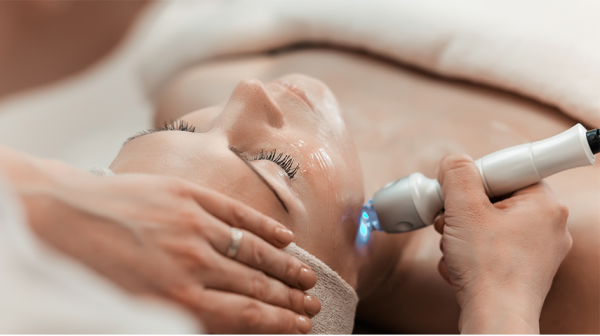 Closeup of woman enjoying light therapy on her face