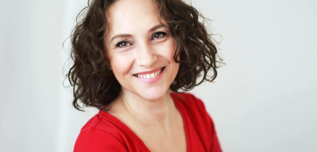 Happy smiling middle-age woman with short wavy hair